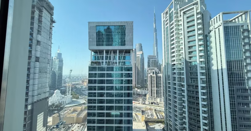 Business traveler enjoying a comfortable stay in Dubai with city skyline in the background