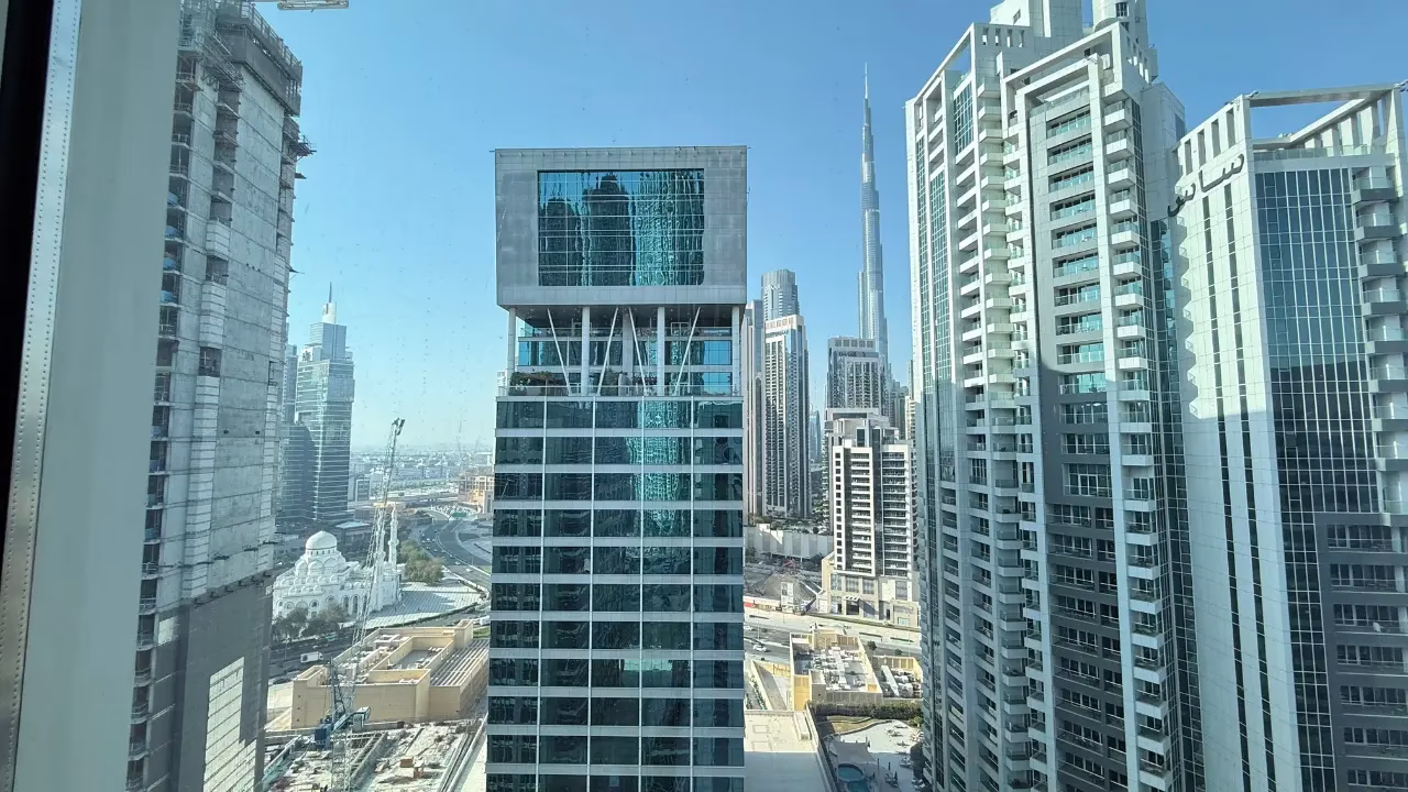 Business traveler enjoying a comfortable stay in Dubai with city skyline in the background